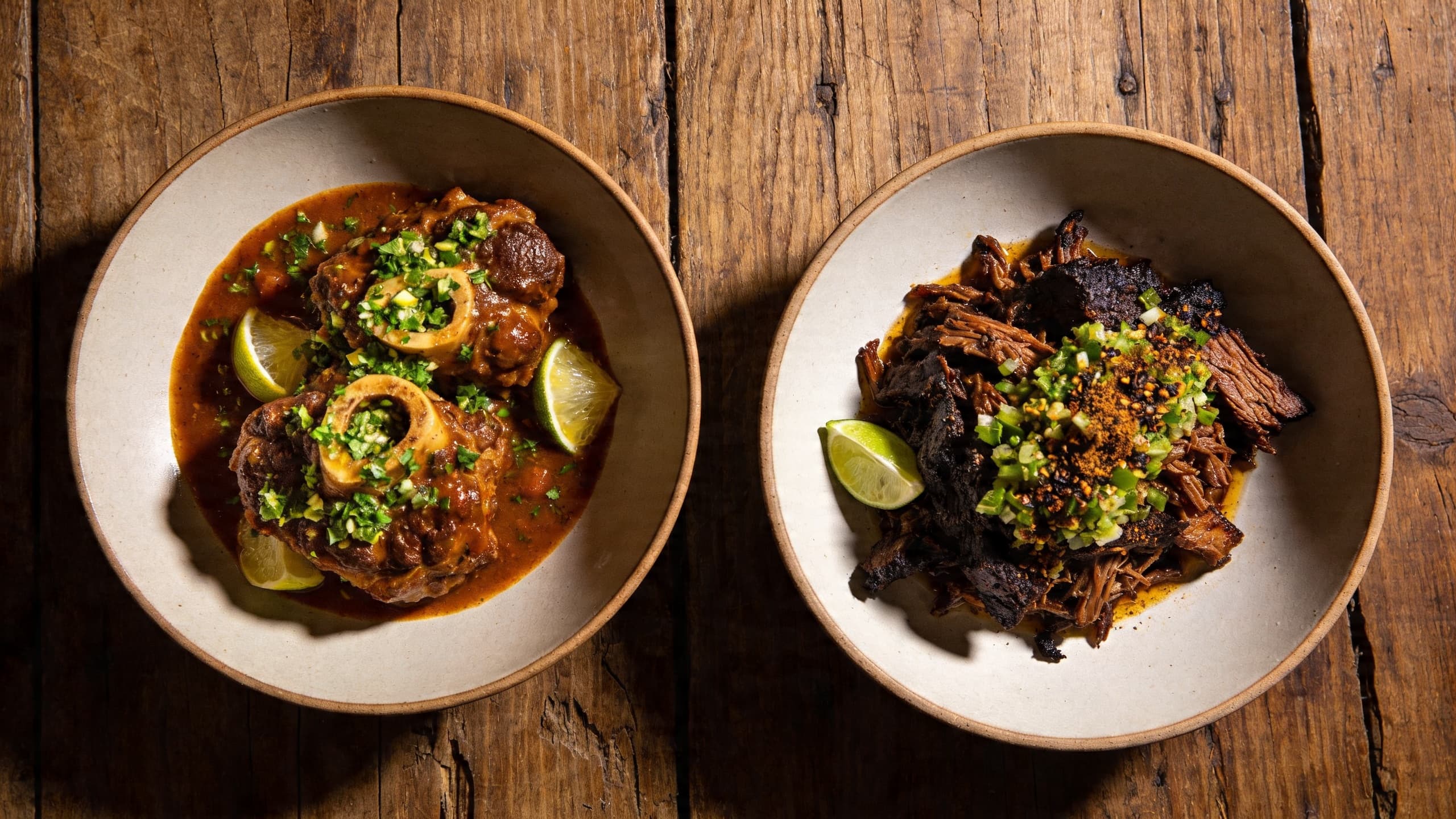 A side-by-side comparison: On the left, a traditional Osso Buco with classic gremolata; on the right, my Smoked Lamb Barbacoa with a charred lime and cumin fusion gremolata.